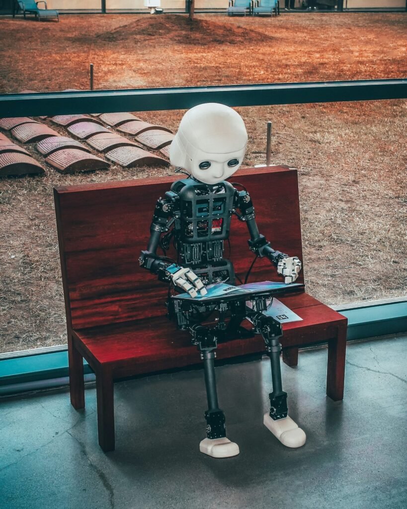 Microsoft Copilot PCs (black and white robot toy on red wooden table-AI image)